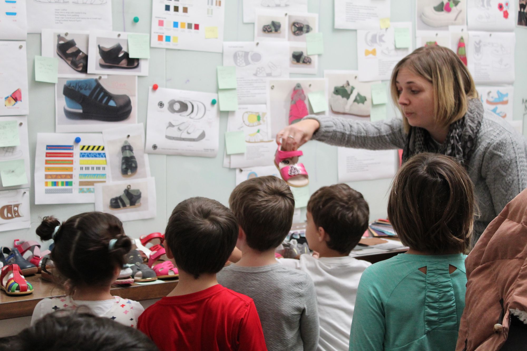 Classroom being shown examples of shoe production.